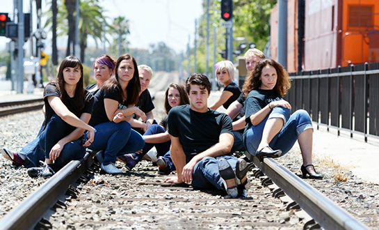 tap dancers posed on train track